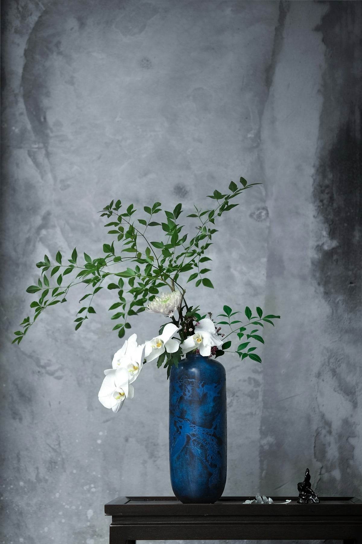 White flowers in a blue vase, gift-style arrangement