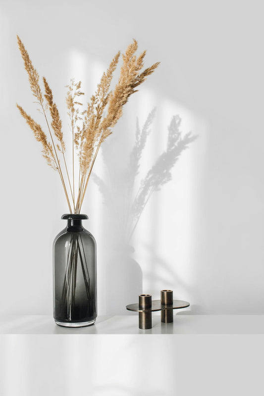 Dried grasses in a black vase